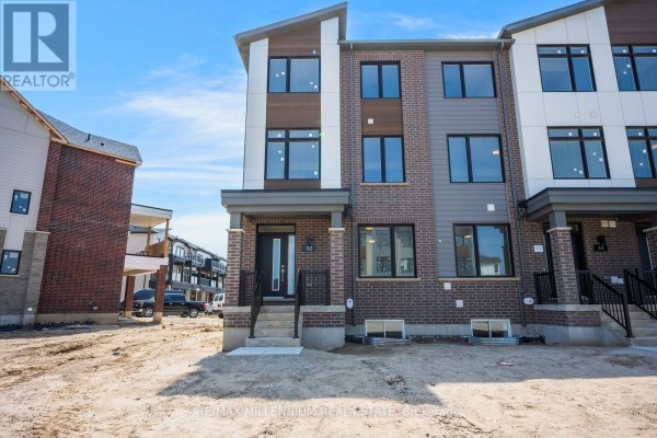 Front facade of a townhouse with brick, grey, and wood paneling, dark windows, and concrete steps. - Main - 50 Thornbird Crescent, Brampton