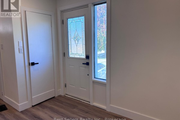 Interior entryway with a white door, side window, and light-colored walls. - Main - 767 Gaspe Avenue, Oshawa