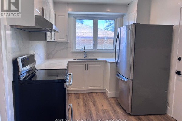 Kitchen with white cabinets, stainless steel appliances, and a quartz countertop. - Main - 767 Gaspe Avenue, Oshawa