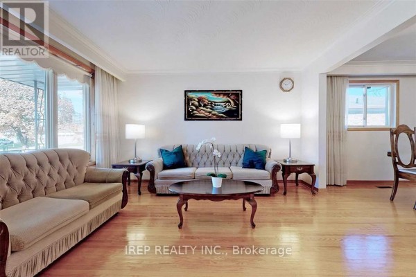 Living room with a tufted sofa, armchairs, coffee table, and wood floors. - Main - 94 Iangrove Terrace, Toronto