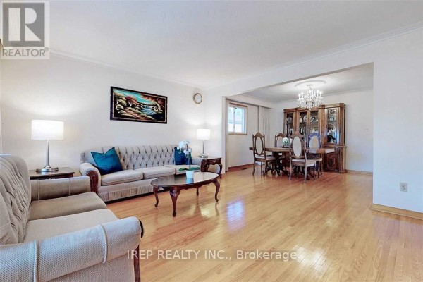 Open concept living and dining area with hardwood floors, chandelier, and furniture. - Main - 94 Iangrove Terrace, Toronto