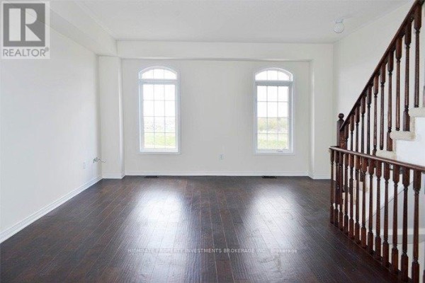 Living room with dark hardwood floors and two arched windows. - Main & Upper - 6 Harper Hill Drive, Ajax