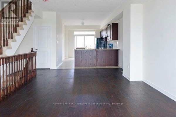 View of the dark hardwood floor, staircase, and open-concept kitchen area. - Main & Upper - 6 Harper Hill Drive, Ajax