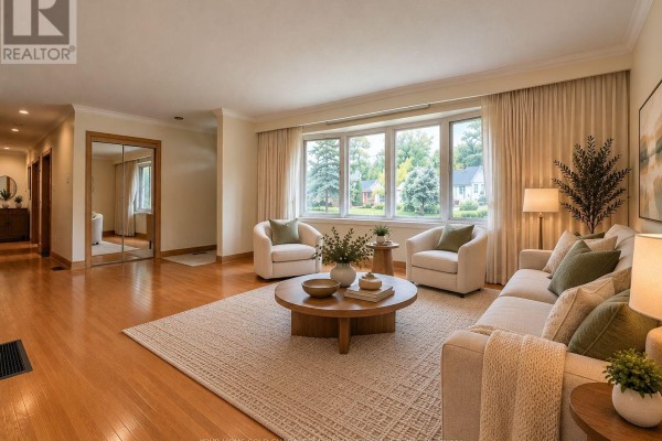 Living room with a large bay window, neutral sofa, chairs, and round coffee table. - Main Floor - 37 Downsview Drive, Barrie