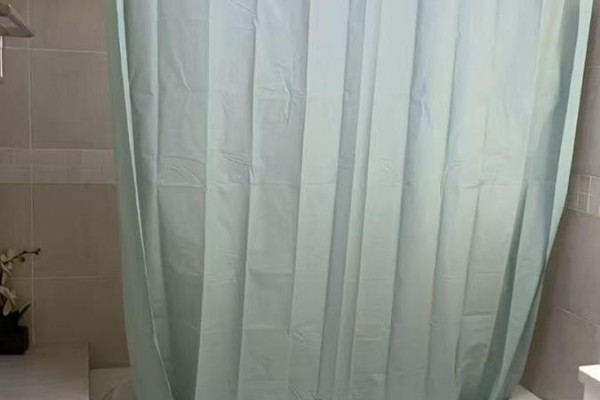 Shower stall with a pale blue shower curtain and beige tiled walls. - Main Floor - 379 Apache Trail, Toronto