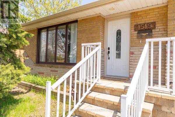 Close-up of the front entrance with a white door, number 1519, and stone and brick accents. - Main Flr - 1519 Lakeside Street, Oshawa