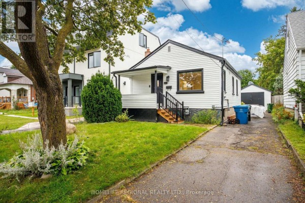 Front view of a white bungalow with a covered porch and green lawn. - Main Level - 21 Acorn Avenue, Toronto
