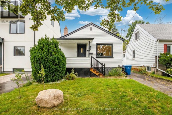 Exterior of a white house with a small porch and manicured lawn. - Main Level - 21 Acorn Avenue, Toronto