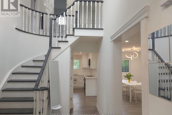 Interior foyer with a curved staircase, white railings, and hardwood floors leading to the kitchen and dining area. - Main2nd - 413 Carrville Road, Richmond Hill