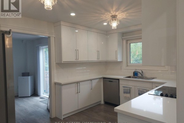 White kitchen with subway tile backsplash, quartz countertops, dishwasher, and sink. View of the backyard door. - Main2nd - 413 Carrville Road, Richmond Hill