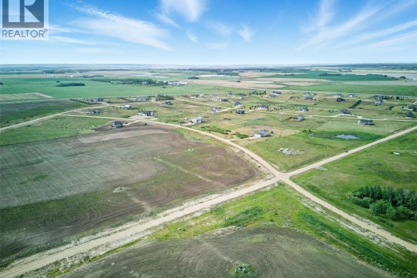 Wide aerial shot of Meadowlark Estates development showing houses and undeveloped land under a cloudy sky. - Meadowlark Development Package, Blucher Rm No  343