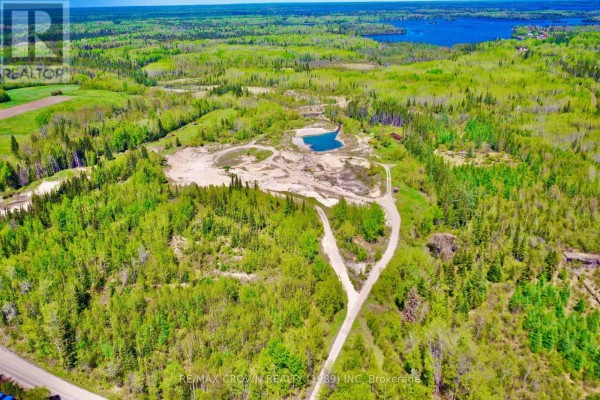 Winding dirt roads cut through a vast forested property with a central quarry and lake. - Moonbeam - 187-a Ouellette Bay Road, Kapuskasing