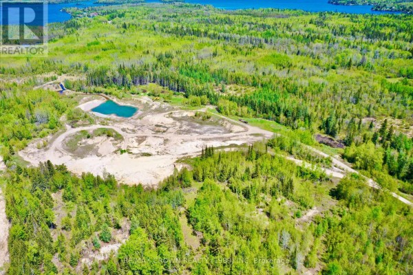 Panoramic aerial view of a sprawling property featuring a quarry, lake, and dense woodlands. - Moonbeam - 187-a Ouellette Bay Road, Kapuskasing