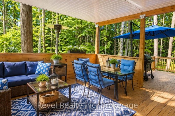 Outdoor deck with sofa, dining set, grill, heater & blue umbrella - 157 Desroches Trail Tiny