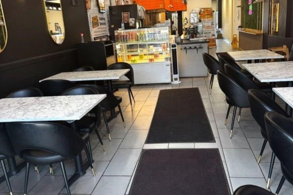 Stainless steel commercial griddle and deep fryer with fry baskets in a restaurant kitchen. - N3 - 90 Courtneypark Drive, Mississauga