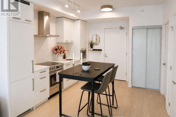 Combined living and kitchen space with artwork and natural light - N431 - 455 Front Street E, Toronto