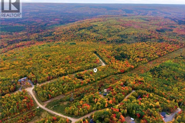 Aerial view of a rural area with winding roads, forested hills, and scattered homes in autumn. - Na Raven Ridge Road, Central Hainesville
