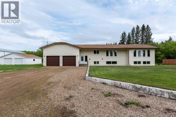 Exterior of a beige house with a brown roof, double garage doors, and large windows. - Ne 19-47-23-w3 Rm Eldon, Maidstone