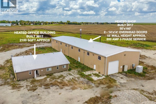 Exterior view of a brown heated office building and a long tan heated shop. - Nw 17-14-15 W2m, Francis Rm No  127