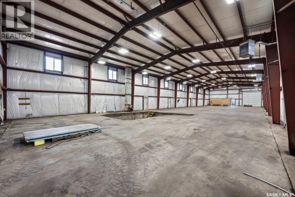Interior view of a large empty commercial shop with concrete floor and exposed metal beams. - Nw 17-14-15 W2m, Francis Rm No  127