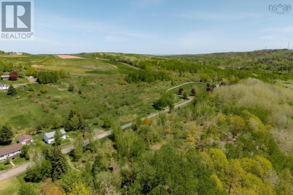 Wide aerial shot of rolling green hills and distant tree lines. - Oak Street, Trenton, Trenton