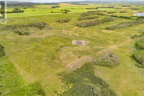 Aerial perspective of a large rural property featuring open fields and wooded areas. - On Range Rd 215, Rural Stettler No  6, County Of