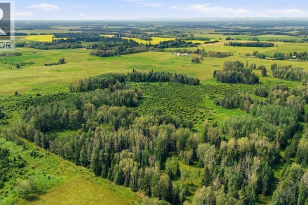 Expansive rural landscape with mixed forests and open fields under a clear blue sky. - On Range Road 45, Rural Clearwater County