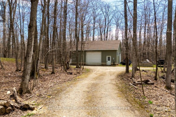 A gravel driveway leads to a detached garage with two bays. - Part 10 Tammy's Cove Road, Northern Bruce Peninsula