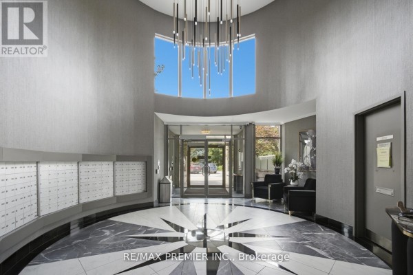 Building lobby with grey textured walls, marble floor, and modern chandelier. - Ph 21 - 8201 Islington Avenue, Vaughan