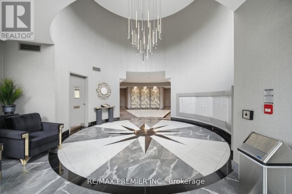 Building lobby with mailboxes, grey textured walls, marble floor, and seating area. - Ph 21 - 8201 Islington Avenue, Vaughan