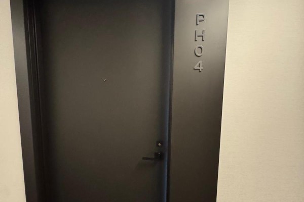 Dark grey apartment door with raised P H O 4 numbering and a peephole. - Ph04 - 28 Eastern Avenue, Toronto