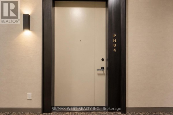 Apartment entrance door labeled "P H 04" with modern wall sconce lighting. - Ph04 - 858 Dupont Street, Toronto
