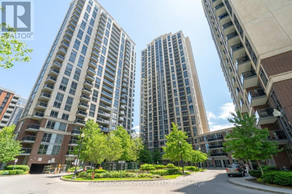 View of tall apartment buildings with balconies and surrounding green trees. - Ph2 - 3 Michael Power Place, Toronto