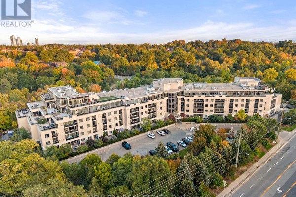 Aerial view of a multi-story apartment building surrounded by trees in autumn. - Ph20 - 8201 Islington Avenue, Vaughan