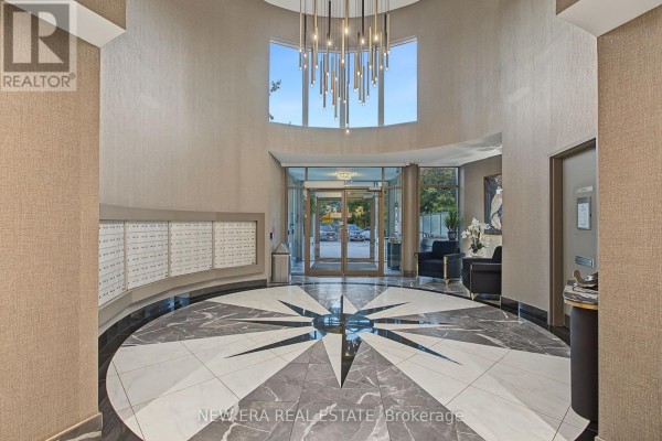 Building lobby with a geometric marble floor, textured walls, and a modern chandelier. - Ph20 - 8201 Islington Avenue, Vaughan