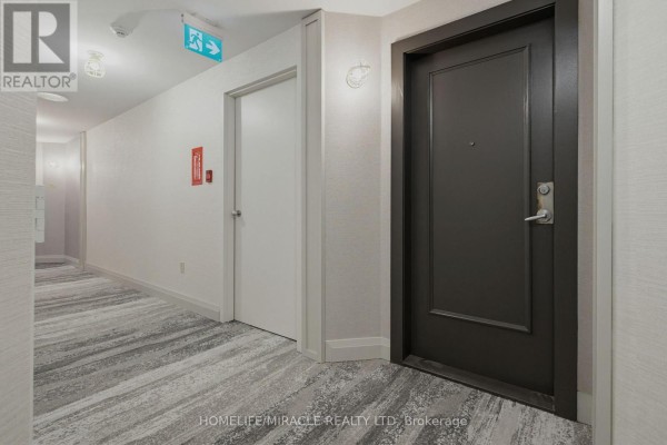 Kitchen area with stainless steel refrigerator, dark wood cabinets, tiled backsplash, and a large window. - Ph211 - 7250 Yonge Street, Vaughan