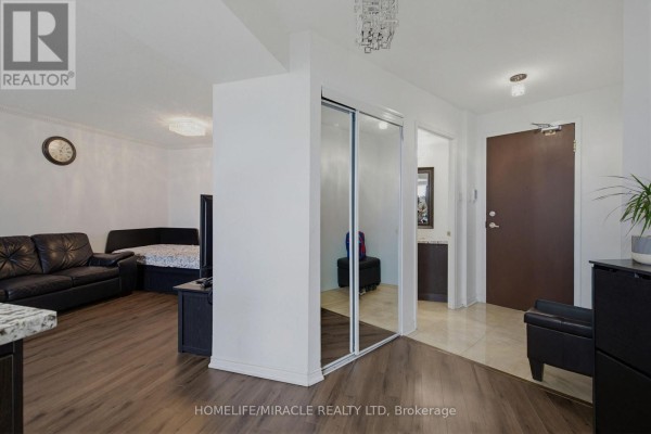 Kitchen with stainless steel appliances, dark cabinets, granite countertops, and mosaic tile backsplash. - Ph211 - 7250 Yonge Street, Vaughan