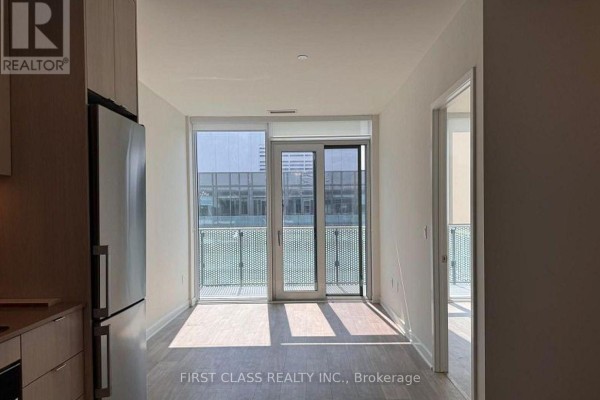 Compact kitchen with light wood cabinets, stainless steel appliances, and a white tiled backsplash. - Ph3015 - 70 Princess Street, Toronto