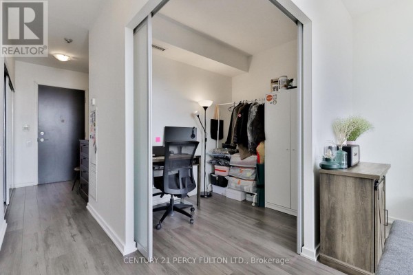 View of hallway, entryway, and an open den area with a desk and storage. - Ph3505 - 105 The Queensway Avenue, Toronto