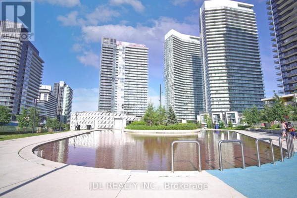 Outdoor pool area surrounded by residential towers and landscaped gardens. - Ph4101 - 95 Mcmahon Drive, Toronto