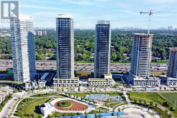 Aerial view of residential towers with green space and city skyline in the background. - Ph4101 - 95 Mcmahon Drive, Toronto