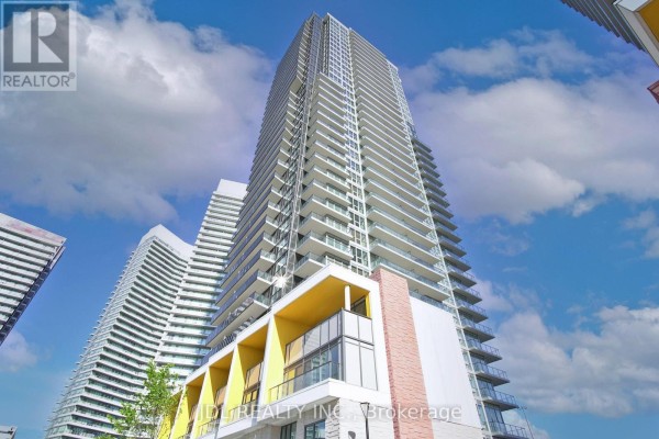 Low-angle view of a high-rise building featuring a distinctive orange entrance. - Ph4101 - 95 Mcmahon Drive, Toronto