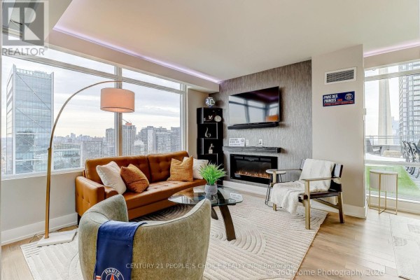 View of open layout with dining area, kitchen, and staircase leading to upper level. - Ph5201 - 25 Telegram Mews, Toronto