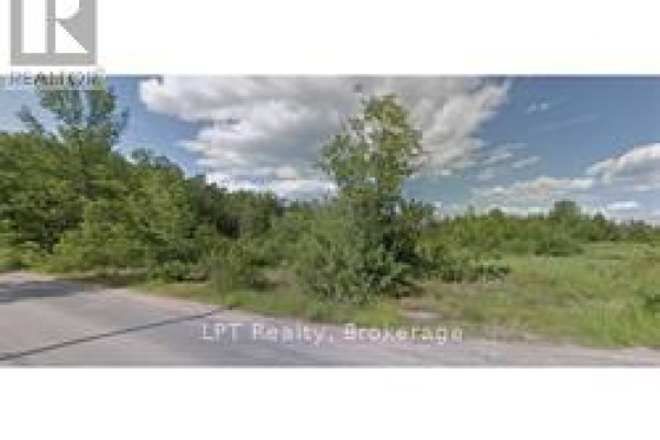 Open land with scattered trees and a paved road at the edge. - Pt 3 Lot 8 Marble Point Road, Marmora And Lake