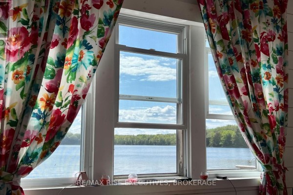 Rope railing with wooden posts overlooking a lake and green trees. - Pt Lt 14 K&p Trail, Frontenac