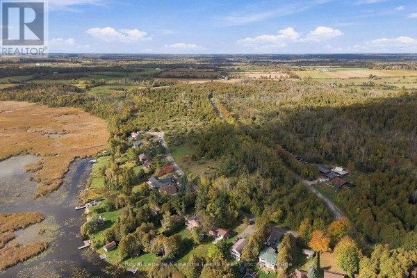 Aerial view showing a large wooded property bordered by a lake and rural landscape. - Pt Lt 17 Southside Road, Kawartha Lakes