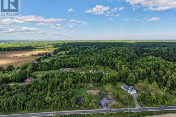 Expansive aerial view of a property with scattered homes, ponds, and dense woodland. - Pt Lt 23 Drouin Road, Clarence Rockland