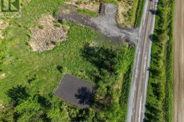 Overhead view of a rural land plot with gravel areas, grass, and a nearby road. - Pt Lt 23 Drouin Road, Clarence Rockland