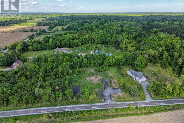 Wide aerial view showing multiple residences nestled within a vast, tree-covered landscape. - Pt Lt 23 Drouin Road, Clarence Rockland