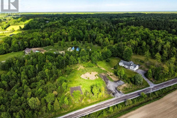 High aerial perspective of cleared land adjacent to woodland, with a house visible. - Pt Lt 23 Drouin Road, Clarence Rockland